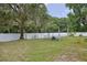 Backyard with large oak tree and fenced koi pond at 1319 Orange Tree Dr, Edgewater, FL 32132