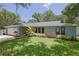 Ranch-style home with a large yard and attached garage at 1319 Orange Tree Dr, Edgewater, FL 32132