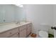 Bathroom with a single sink vanity, toilet and a large mirror at 1319 Orange Tree Dr, Edgewater, FL 32132