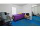 Small bedroom with purple bedding and blue carpet at 1319 Orange Tree Dr, Edgewater, FL 32132