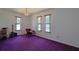 Spacious bedroom with hardwood floors, three windows, and ample natural light at 1319 Orange Tree Dr, Edgewater, FL 32132