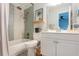 Updated bathroom with a white vanity, mosaic tile shower, and a bathtub at 3750 S Atlantic Ave # 180, Daytona Beach Shores, FL 32118
