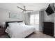 Bedroom with king-size bed, ceiling fan, and gray dresser at 3750 S Atlantic Ave # 180, Daytona Beach Shores, FL 32118