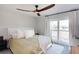 Bedroom with a king-size bed, balcony access and ceiling fan at 3750 S Atlantic Ave # 180, Daytona Beach Shores, FL 32118