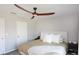 King-size bed in a bedroom with ceiling fan and neutral walls at 3750 S Atlantic Ave # 180, Daytona Beach Shores, FL 32118