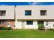 Tan and brick condo building with green lawn and ocean view at 3750 S Atlantic Ave # 180, Daytona Beach Shores, FL 32118