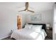 King-size bed in bedroom with ceiling fan and ensuite bathroom at 3750 S Atlantic Ave # 180, Daytona Beach Shores, FL 32118