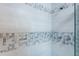 Shower with gray and white mosaic tile and glass door at 3750 S Atlantic Ave # 180, Daytona Beach Shores, FL 32118