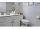 Simple bathroom with white vanity, toilet, and decorative vase at 3750 S Atlantic Ave # 180, Daytona Beach Shores, FL 32118