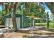 Metal workshop with double doors and shaded area at 3650 Pepper Ln, New Smyrna Beach, FL 32168