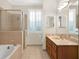 Bathroom with double vanity, shower, and bathtub at 3650 Pepper Ln, New Smyrna Beach, FL 32168