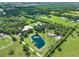 Aerial view showing a house, pond, and riding arena on a large lot at 3650 Pepper Ln, New Smyrna Beach, FL 32168