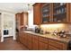 Spacious kitchen featuring wood cabinets, granite counters and laundry access at 3650 Pepper Ln, New Smyrna Beach, FL 32168