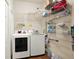 Laundry room with washer, dryer, and ample shelving at 3650 Pepper Ln, New Smyrna Beach, FL 32168