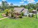 Single story house with a large yard, palm trees and a patio at 3650 Pepper Ln, New Smyrna Beach, FL 32168
