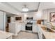 Bright kitchen with granite countertops and white cabinets at 4650 Links Village Dr # D-501, Ponce Inlet, FL 32127