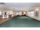 Large open community room with carpeting and bar at 4650 Links Village Dr # D-501, Ponce Inlet, FL 32127