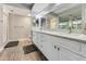 Elegant bathroom with double vanity and a large mirror at 4650 Links Village Dr # D-501, Ponce Inlet, FL 32127