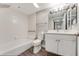 Clean bathroom with a tub, toilet and vanity at 4650 Links Village Dr # D-501, Ponce Inlet, FL 32127