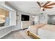 Bright bedroom with a king-size bed, dresser, and large window at 4650 Links Village Dr # D-501, Ponce Inlet, FL 32127