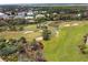 Aerial view of a green golf course near the ocean at 4650 Links Village Dr # D-501, Ponce Inlet, FL 32127