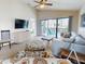 Living room features comfortable seating and a large TV at 406 Bouchelle Dr # 206, New Smyrna Beach, FL 32169