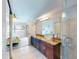 Bathroom with granite countertop, large mirror and walk-in shower at 406 Bouchelle Dr # 206, New Smyrna Beach, FL 32169
