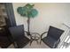 Small balcony with two wicker chairs and a small table at 4175 S Atlantic Ave # 4120, New Smyrna Beach, FL 32169