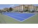 Blue tennis court with green perimeter at 4175 S Atlantic Ave # 4120, New Smyrna Beach, FL 32169