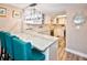 Modern kitchen with white cabinets, stainless steel appliances, and a breakfast bar at 4175 S Atlantic Ave # 4120, New Smyrna Beach, FL 32169