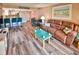 Open living room and kitchen with hardwood floors and comfortable seating at 4175 S Atlantic Ave # 4120, New Smyrna Beach, FL 32169