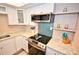 Modern kitchen with teal hexagon backsplash and stainless steel appliances at 4175 S Atlantic Ave # 4120, New Smyrna Beach, FL 32169