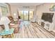 Bright living room with ocean view, comfy furniture, and wood-look floors at 4175 S Atlantic Ave # 4120, New Smyrna Beach, FL 32169
