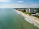 Aerial view of beach, ocean, and residential buildings at 5301 S Atlantic Ave # 52, New Smyrna Beach, FL 32169