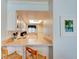 Efficient kitchen with white cabinets and breakfast bar at 5301 S Atlantic Ave # 52, New Smyrna Beach, FL 32169