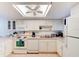 Well-equipped kitchen with white cabinets and appliances at 5301 S Atlantic Ave # 52, New Smyrna Beach, FL 32169