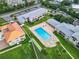 Aerial view of condo community with pool, lush landscaping, and ocean access at 2100 N Peninsula Ave # 1150, New Smyrna Beach, FL 32169