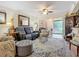 Bright living room with comfy seating, a stylish rug, and views to the backyard at 2100 N Peninsula Ave # 1150, New Smyrna Beach, FL 32169