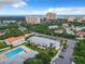 Aerial view of condo community with pool, parking and ocean view at 2100 N Peninsula Ave # 1150, New Smyrna Beach, FL 32169