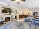 Open living space featuring a fireplace and kitchen access at 2100 N Peninsula Ave # 1150, New Smyrna Beach, FL 32169
