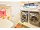 Laundry room with washer, dryer, and built-in shelving at 2624 Turnbull Estates Dr, New Smyrna Beach, FL 32168