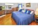 Bright main bedroom with hardwood floors, a king-size bed, and plenty of closet space at 2624 Turnbull Estates Dr, New Smyrna Beach, FL 32168