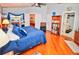 Spacious main bedroom with hardwood floors, king-size bed, and access to the bathroom at 2624 Turnbull Estates Dr, New Smyrna Beach, FL 32168