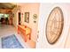 Bright entryway with a wooden console table and stained glass at 2624 Turnbull Estates Dr, New Smyrna Beach, FL 32168