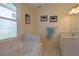 Relaxing bathroom with soaking tub, double vanity, and large window at 320 Due East St, New Smyrna Beach, FL 32169