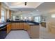 Open kitchen features a large island and views into the living area at 320 Due East St, New Smyrna Beach, FL 32169