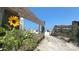 Image of a wooden walkway leading to the beach with sunflowers at 320 Due East St, New Smyrna Beach, FL 32169