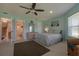 Spacious bedroom with a ceiling fan, large windows, and a view of the backyard at 320 Due East St, New Smyrna Beach, FL 32169