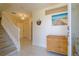 Bright and airy entryway with a staircase, tile floors, and wicker chest at 320 Due East St, New Smyrna Beach, FL 32169