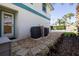 The backyard features a spacious patio, AC units, and a walkway at 320 Due East St, New Smyrna Beach, FL 32169